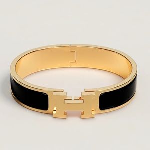 Hermes small black and gold Clic H bracelet